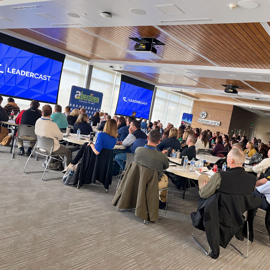 A full room at the Aberdeen Chamber's Leadercast event, facing screens showing the Leadercast and Aberdeen logos