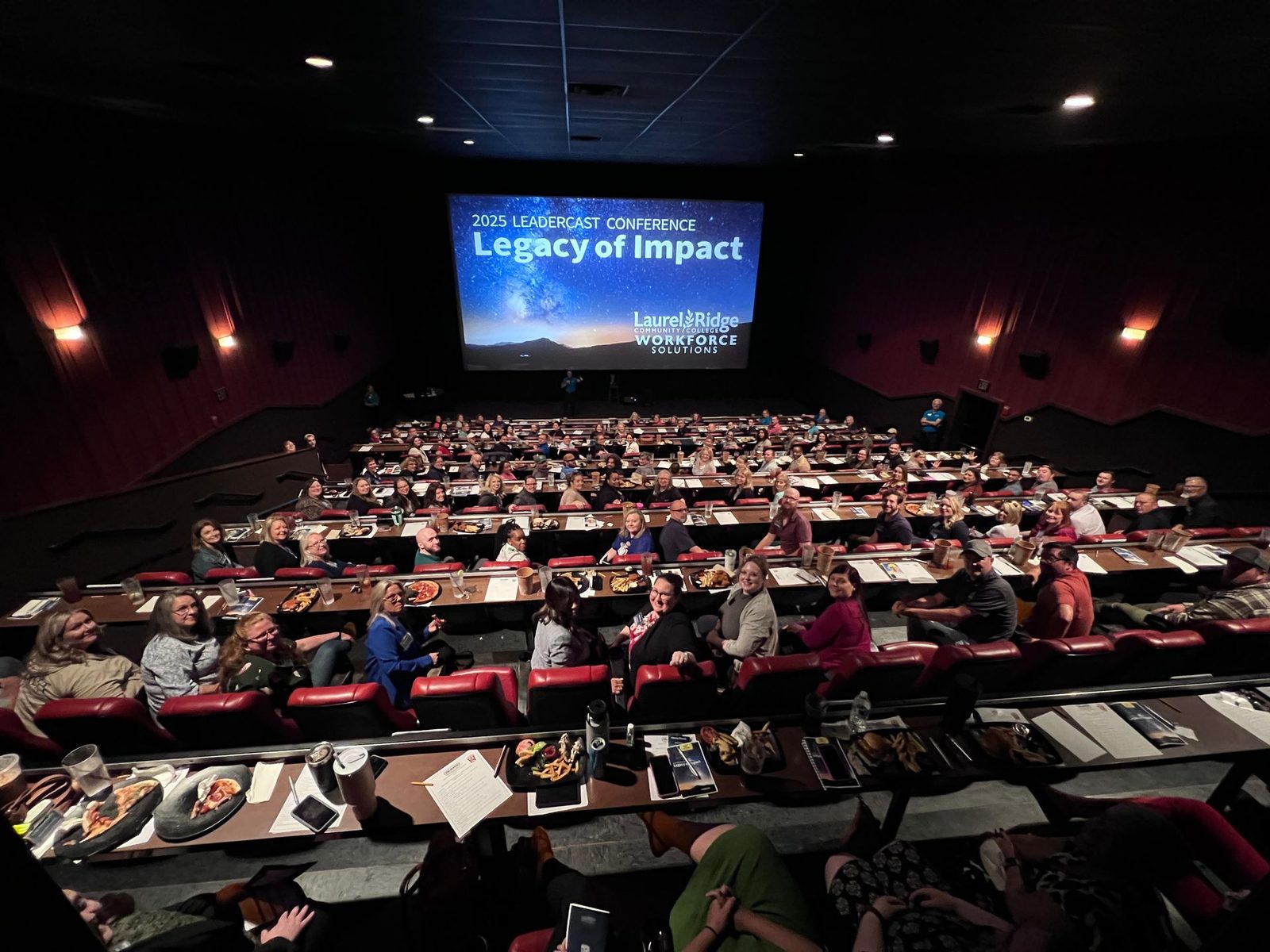 A full theater at the Alamo Drafthouse in Winchester watching Leadercast 2025: Legacy of Impact, hosted by Laurel Ridge Workforce Solutions