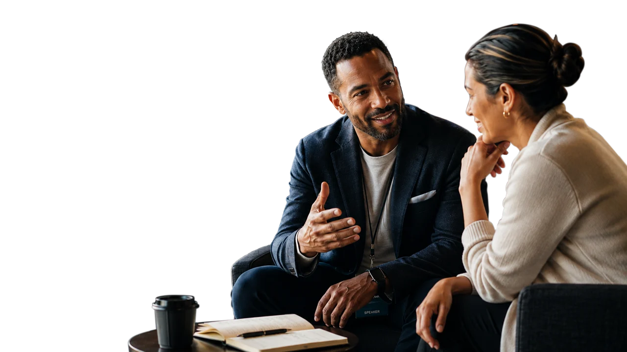 Two professionals in conversation over coffee