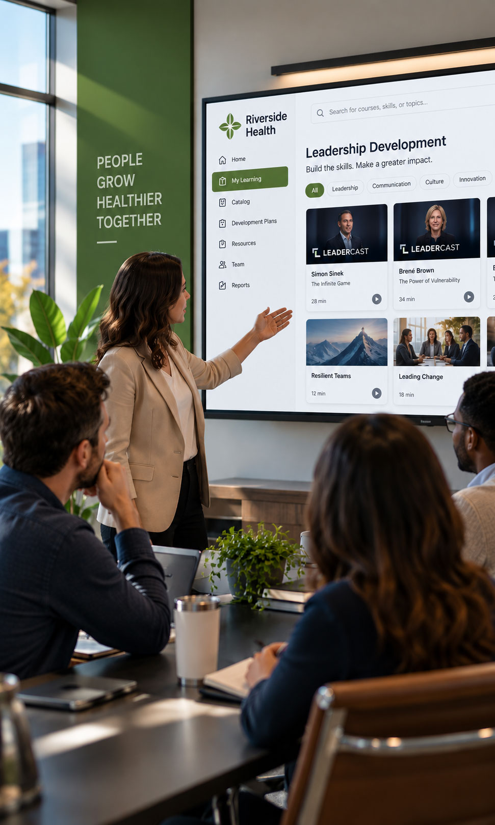 A team reviewing a Leadercast leadership development program on a screen